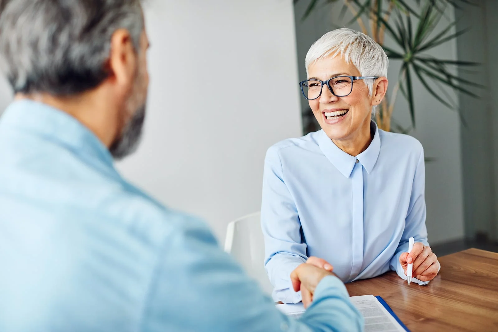 woman shaking hands with man